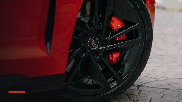Red sports car wheel and tyre on a sunny street
