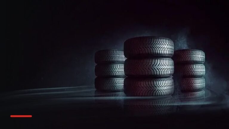 Stacks of new tyres on a dark floor